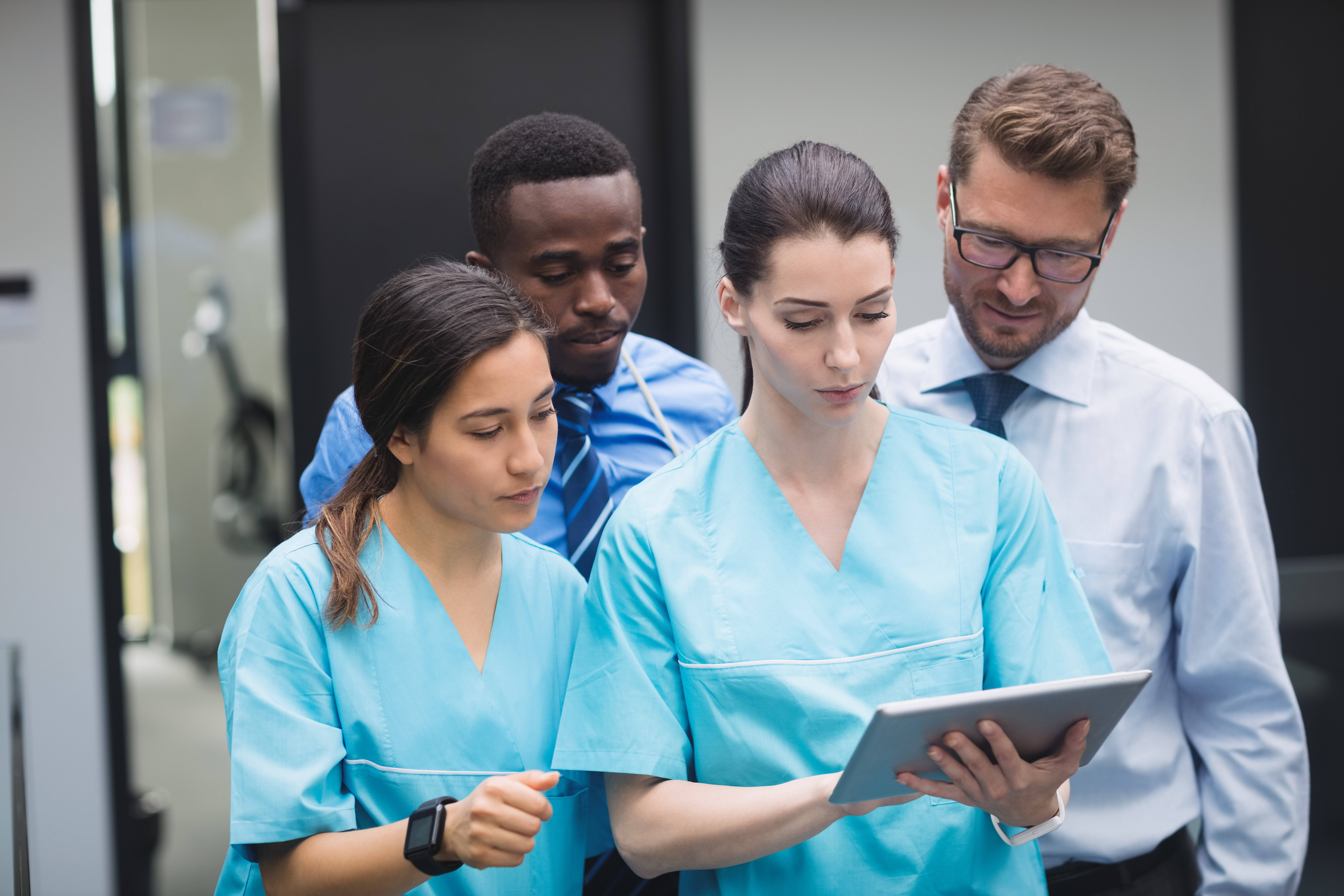 medical-team-discussing-over-digital-tablet.jpg
